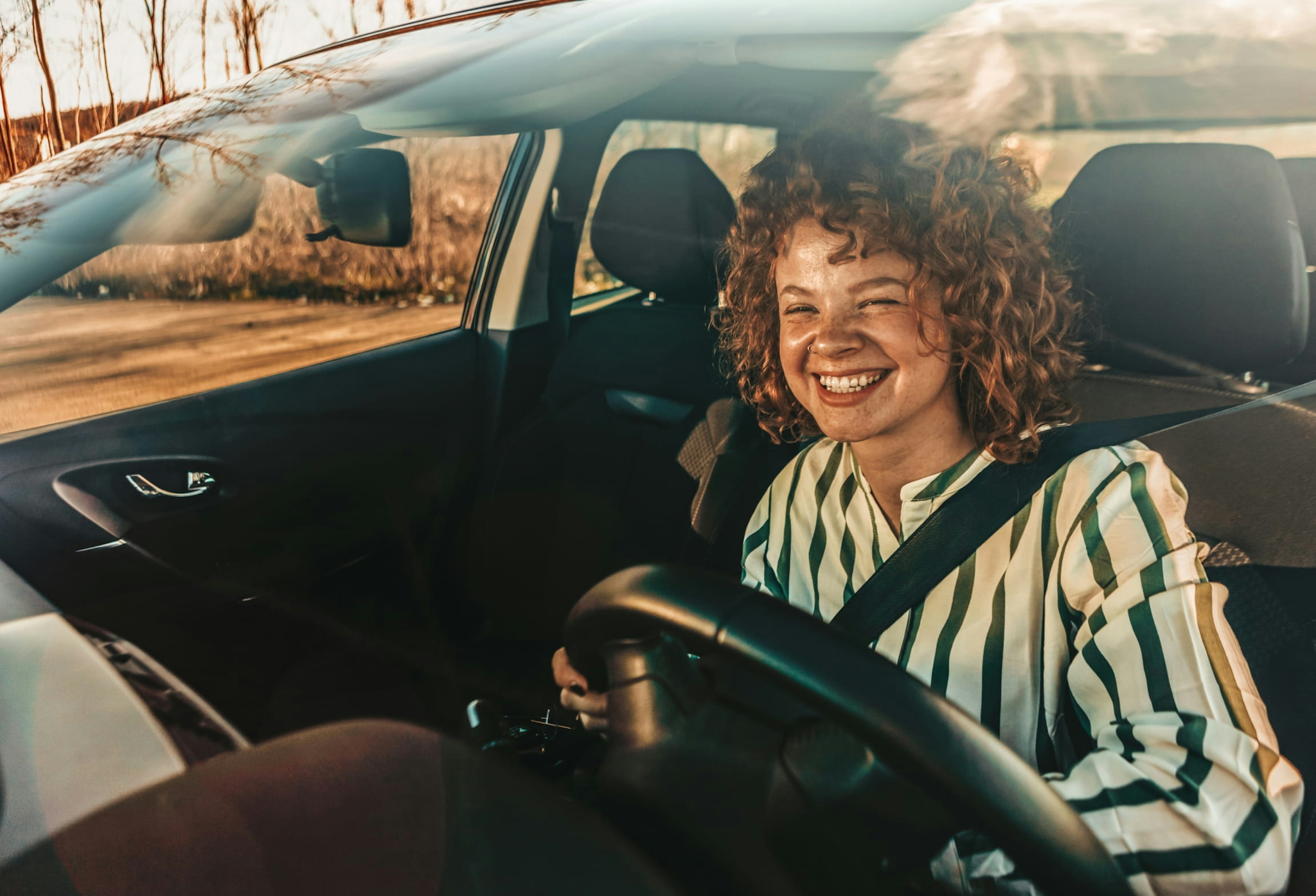 Woman smiling while at the driver seat